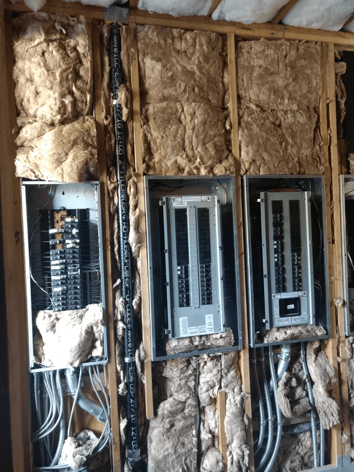 3 circuit breaker panels in open insulated wall