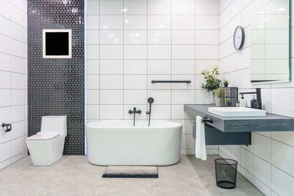 contemporary master bathroom with white and black fixtures.
